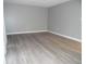 Open living area featuring gray walls and modern, wood-look floors at 723 Perkins St # 104, Leesburg, FL 34748