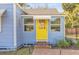 Inviting front entrance with a bright yellow door, brick steps, and manicured landscaping at 805 Hackett Ct, Mount Dora, FL 32757