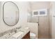 Bathroom featuring granite countertop, glass shower door, and stylish fixtures at 1029 Juliette Blvd, Mount Dora, FL 32757