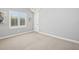 Bedroom with carpet, window with plantation shutters, and a modern light fixture at 1029 Juliette Blvd, Mount Dora, FL 32757