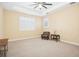 Bright, empty bedroom with neutral carpet, plantation shutters, and comfortable furniture at 1029 Juliette Blvd, Mount Dora, FL 32757