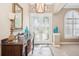 Inviting foyer featuring tile flooring, a chandelier, and a decorative console table at 1029 Juliette Blvd, Mount Dora, FL 32757