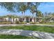 Elegant home featuring well manicured landscaping, a circular driveway and a welcoming entrance at 1029 Juliette Blvd, Mount Dora, FL 32757