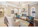 Well-lit living room with a stone fireplace, hardwood floors, and stylish seating at 1029 Juliette Blvd, Mount Dora, FL 32757