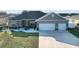 Gray house with two-car garage and landscaped lawn at 10300 Se 69Th Ter, Belleview, FL 34420