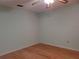 Light and airy bedroom with wood floors and ceiling fan at 10337 Se 176Th St, Summerfield, FL 34491