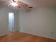 Simple bedroom with wood floors, ceiling fan and access to bathroom at 10337 Se 176Th St, Summerfield, FL 34491