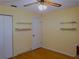 Simple bedroom with wood floors, shelves and ceiling fan at 10337 Se 176Th St, Summerfield, FL 34491