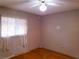 Bedroom with hardwood floors, ceiling fan, and window at 10337 Se 176Th St, Summerfield, FL 34491