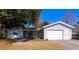 Light blue house with a two-car garage and paved driveway at 10337 Se 176Th St, Summerfield, FL 34491