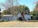 Back of house showing screened porch and palm trees at 10337 Se 176Th St, Summerfield, FL 34491