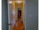 Long hallway with light wood floors connecting the rooms of the house at 10337 Se 176Th St, Summerfield, FL 34491