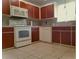 Kitchen with wood cabinets and white appliances at 10337 Se 176Th St, Summerfield, FL 34491