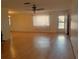 Spacious living room featuring hardwood floors and a ceiling fan at 10337 Se 176Th St, Summerfield, FL 34491