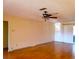 Spacious living room featuring wood floors and a ceiling fan at 10337 Se 176Th St, Summerfield, FL 34491