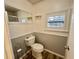 Updated bathroom with toilet, shower, and window with plantation shutters at 105 Royal Palm Dr, Leesburg, FL 34748