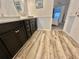 Double vanity bathroom with dark cabinets and wood-look flooring at 105 Royal Palm Dr, Leesburg, FL 34748