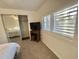 Bedroom with a queen bed and large windows with plantation shutters at 105 Royal Palm Dr, Leesburg, FL 34748