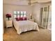 Main bedroom with plush carpeting and access to sunroom at 105 Royal Palm Dr, Leesburg, FL 34748