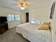 Bedroom with a queen bed, ceiling fan, and plenty of natural light at 105 Royal Palm Dr, Leesburg, FL 34748