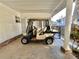 Covered patio with golf cart and partial home view at 105 Royal Palm Dr, Leesburg, FL 34748