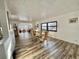 Bright dining room with wood-look floors and view into living room at 105 Royal Palm Dr, Leesburg, FL 34748