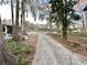 Long driveway leading to community pavilion at 105 Royal Palm Dr, Leesburg, FL 34748