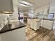 Modern kitchen with white cabinets, granite counters, and island at 105 Royal Palm Dr, Leesburg, FL 34748