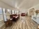 Bright living room featuring wood-look floors and leather furniture at 105 Royal Palm Dr, Leesburg, FL 34748