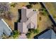 An aerial view showcasing a single-story house and its yard at 1130 Meadowbend Dr, Leesburg, FL 34748