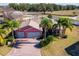 Aerial view of a single-Gathering home with a large backyard and pool at 1130 Meadowbend Dr, Leesburg, FL 34748