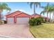 Brick driveway leading to a two-car garage with screened doors at 1130 Meadowbend Dr, Leesburg, FL 34748