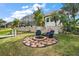 Stone firepit and seating area overlooking the lake at 11644 Osprey Pointe Blvd, Clermont, FL 34711