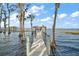 Long wooden dock leading to a gazebo on the lake at 11644 Osprey Pointe Blvd, Clermont, FL 34711