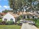 Two-story home with tile roof and landscaped yard at 11644 Osprey Pointe Blvd, Clermont, FL 34711