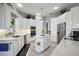 Bright kitchen featuring white cabinetry, stainless steel appliances, and an island at 11644 Osprey Pointe Blvd, Clermont, FL 34711