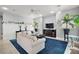 Living room with sectional sofa, blue rug, and built in shelving at 11644 Osprey Pointe Blvd, Clermont, FL 34711