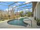 Inviting kidney-shaped pool with screened enclosure and lake view at 11644 Osprey Pointe Blvd, Clermont, FL 34711