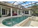 Large kidney shaped pool with covered patio and seating area at 11644 Osprey Pointe Blvd, Clermont, FL 34711