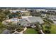 An aerial view of the community center, pool, tennis courts, and surrounding landscape at 12163 Se 176Th Loop, Summerfield, FL 34491