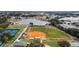 Community aerial view of a lake, tennis courts, a baseball field, and homes in a Gathering-friendly neighborhood at 12163 Se 176Th Loop, Summerfield, FL 34491