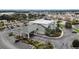 An aerial view of a commercial building with ample parking, featuring well-maintained landscaping at 12163 Se 176Th Loop, Summerfield, FL 34491