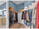 The primary closet includes custom shelving with clothes, and plenty of storage at 12163 Se 176Th Loop, Summerfield, FL 34491