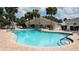 Sparkling pool with plenty of seating under palm trees at 12163 Se 176Th Loop, Summerfield, FL 34491