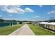 View of tennis courts with walkway and covered area for spectators at 12163 Se 176Th Loop, Summerfield, FL 34491