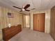 Bedroom with dresser, closet, and ceiling fan at 128 Lake Hazel Dr, Winter Haven, FL 33884