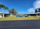 Community features a pond with benches and well-maintained landscaping at 128 Lake Hazel Dr, Winter Haven, FL 33884