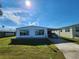 White single-wide manufactured home with carport and landscaped lawn at 128 Lake Hazel Dr, Winter Haven, FL 33884