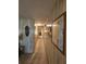 Long hallway with wood paneling and framed art at 128 Lake Hazel Dr, Winter Haven, FL 33884