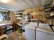 Laundry room with washer, dryer, and storage shelves at 128 Lake Hazel Dr, Winter Haven, FL 33884